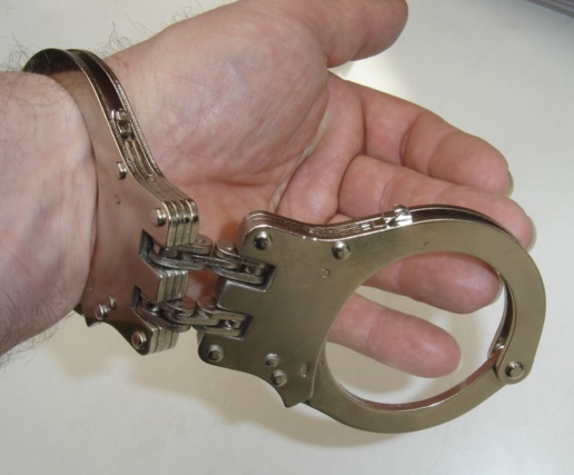 Standard handcuffs with two solid stainless steel links.